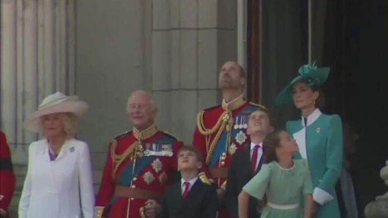 Royal family on balcony.
