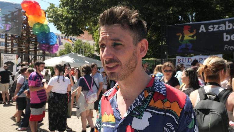 activist Adam Kanicsar speaking at a pride march in Budapest, Hungary