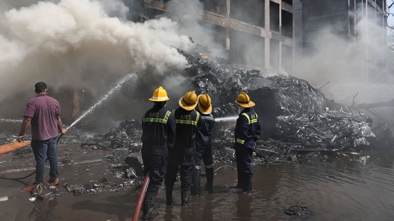 Firefighters work to put out a fire at the site where an Air India plane crashed in Ahmedabad.
Pic: Reuters