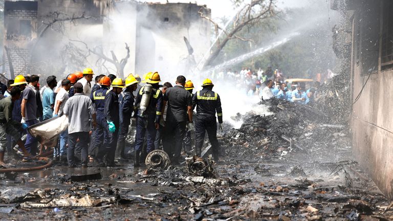 Firefighters work to put out a fire at the site where an Air India Boeing 787 Dreamliner plane crashed in Ahmedabad.
Pic: Reuters