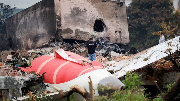 FILE PHOTO: A fire officer stands next to the crashed Air India Boeing 787-8 Dreamliner aircraft, in Ahmedabad, India, June 13, 2025. REUTER