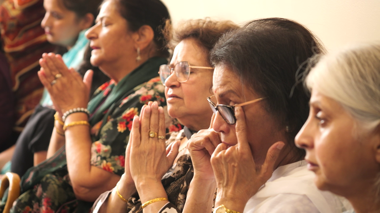 People cry at Geeta Bhawan Hindu temple during a service in Derby for Dr Prateek Joshi, his wife Komi, their daughter and twin sons 