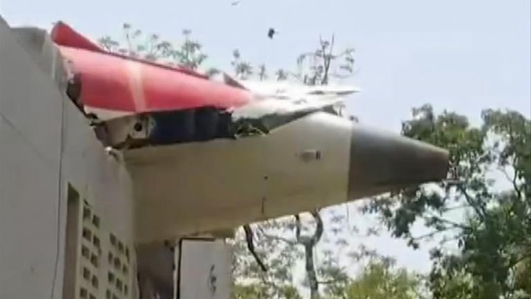 Tail of Air India plane is wedged in roof of building following crash