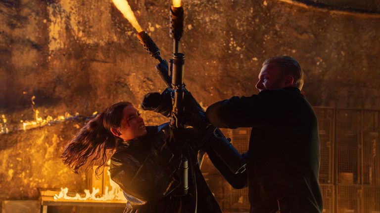Ana de Armas as Eve and Robert Masser as Dex in Ballerina.