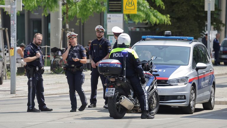 Police officers stand guard near a school following a deadly school shooting in Graz, Austria.
Pic: Reuters
