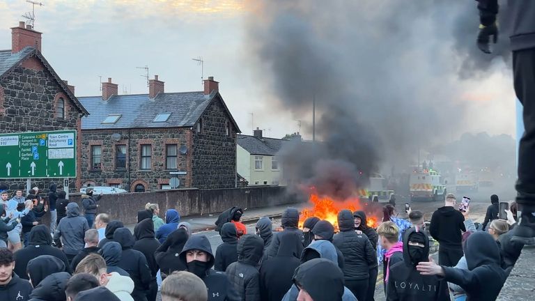 Smoke is billowing into the sky during the protest. Pic: PA