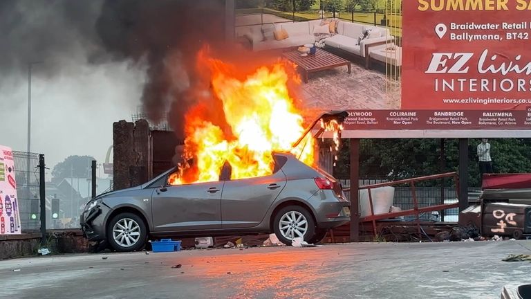 A vehicle on fire near Clonavon Terrace, Ballymena. Pic: PA