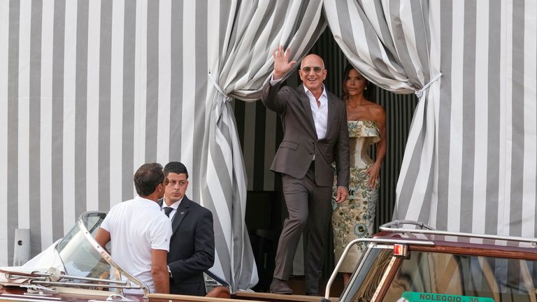 Jeff Bezos, center left, and Lauren Sanchez, center right, leave a hotel for their pre wedding reception, in Venice, Italy, Thursday, June 26, 2025. (AP Photo/Luca Bruno)