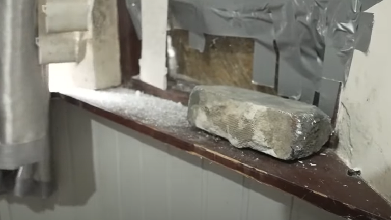A brick was smashed through James's front window