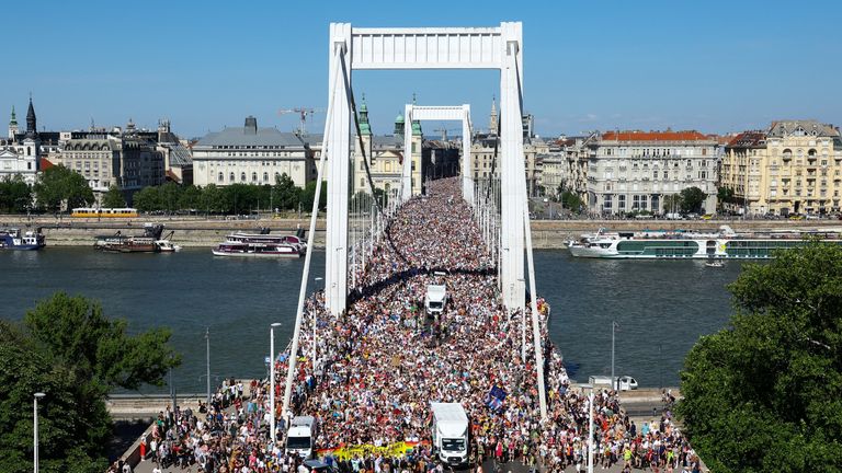 People cross Elisabeth Bridge during the Budapest Pride March in Budapest, Hungary, June 28, 2025. REUTERS/Bernadett Szabo
