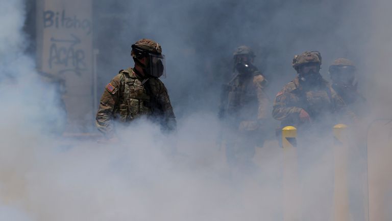Smoke rises as the National Guard clashed with protesters in downtown Los Angeles.
Pic: Reuters/Daniel Cole