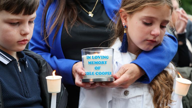 Cole Cooper's mother Wendy Stewart, comforts her son Coby, 10 and daughter Casia, 11, during a vigil at the Glenskirlie Hotel in Banknock, f