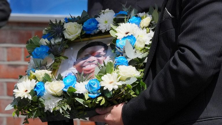 A floral tribute with a photo of Daniel Anjorin, 14, following his funeral in Ilford, east London, in May 2024. Pic: Reuters.