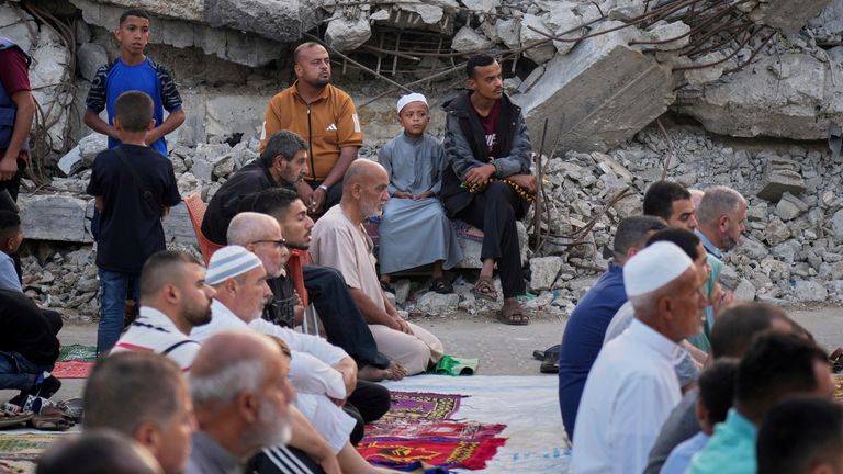 Palestinians attend Eid al Adha prayers beside the ruins of a mosque in Deir al Balah, Gaza. Pic: AP
