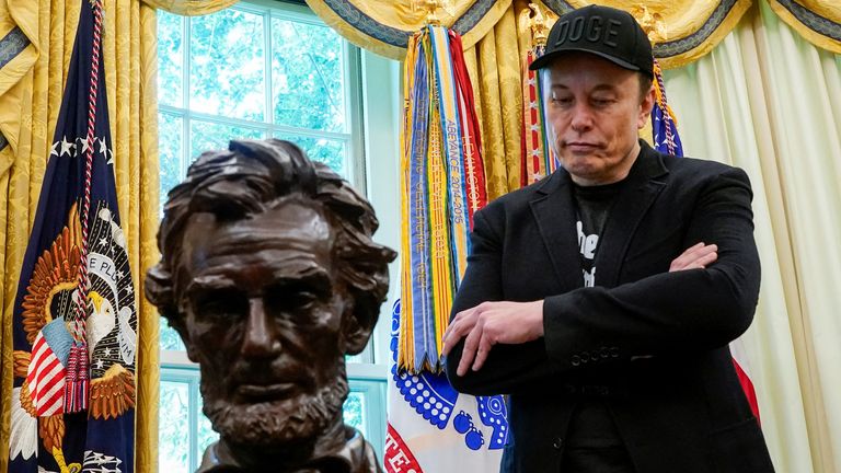 Elon Musk stands in the Oval Office to attend a press conference with Donald Trump. Pic: Reuters