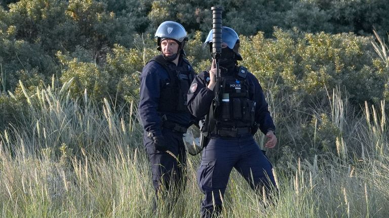 French authorities seen on a beach in Gravelines, France, as they prepare to fire tear gas at a group of people thought to be migrants. Pict
