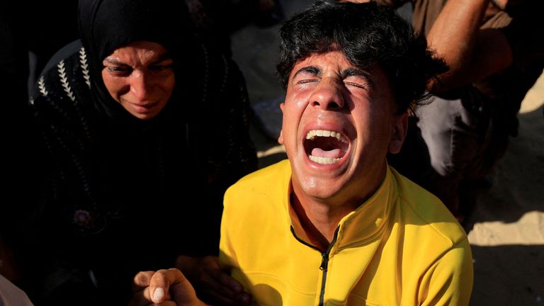 Mourners sob in Khan Younis, after Israeli strikes.
Pic: Reuters/Hatem Khaled