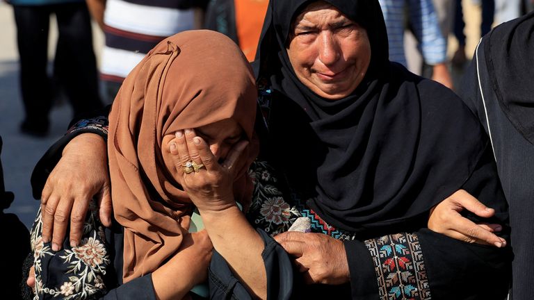 Two women cry during the funeral of Palestinians killed early Tuesday. Pic: Reuters