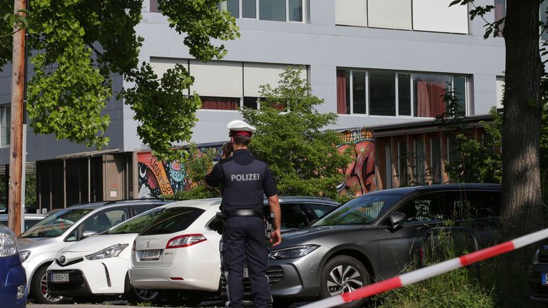 A police officer makes a phone call in front of a school building after a shooting Graz, Austria. Pic: AP