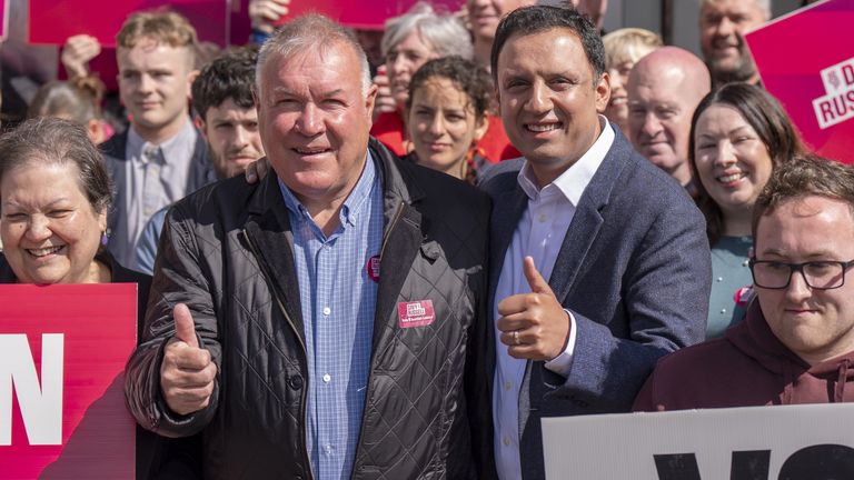 Scottish Labour leader Anas Sarwar (right) joins parliamentary candidate Davy Russell (left) and party activists outside the party's campaig
