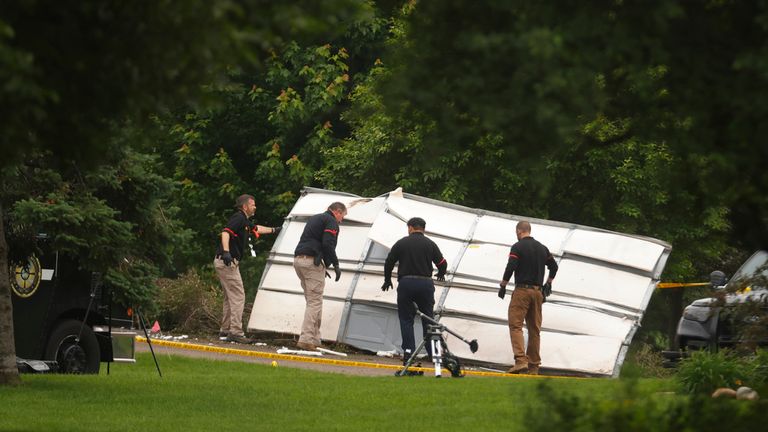 Investigators move debris from the home of Democratic former House Speaker Melissa Hortman and her husband, Mark, who were shot and killed earlier in the day, Saturday, June 14, 2025, in Brooklyn Park, Minn. (AP Photo/Bruce Kluckhohn)