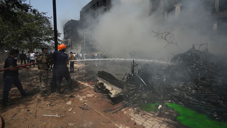 Firefighters work at the site of an airplane that crashed in India's northwestern city of Ahmedabad in Gujarat state, Thursday, June 12, 2025. (AP Photo/Ajit Solanki)