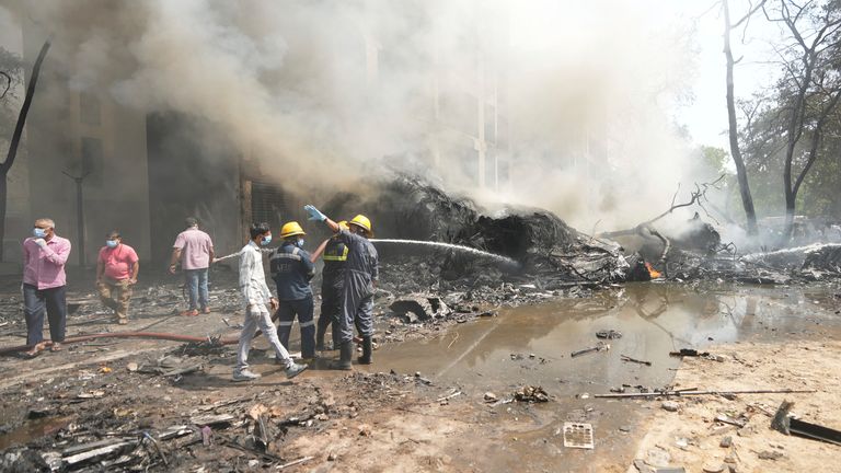 Firefighters work at the site of an airplane that crashed in India's northwestern city of Ahmedabad in Gujarat state, Thursday, June 12, 2025. (AP Photo/Ajit Solanki)