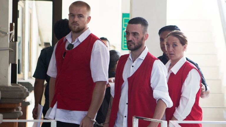 British nationals, from left, Phineas Float, Jonathan Collyer, and Lisa Stocker who are accused of smuggling nearly a kilogram (over two pounds) of cocaine into Indonesia are escorted by security officers before the start of their trial hearing at Denpasar District Court in Denpasar, Bali, on Tuesday, June 3, 2025. (AP Photo/Firdia Lisnawati)