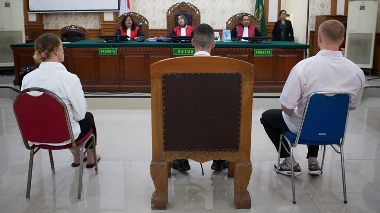 British nationals, from left, Lisa Stocker, Jonathan Collyer, and Phineas Float who are accused of smuggling nearly a kilogram (over two pounds) of cocaine into Indonesia sit on the defendant's chairs during their trial hearing at Denpasar District Court in Denpasar, Bali, on Tuesday, June 3, 2025. (AP Photo/Firdia Lisnawati)