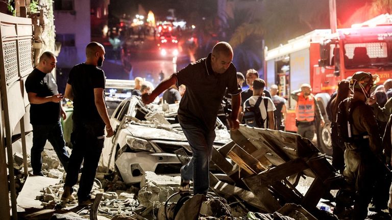 Rescue teams are at the scene of a residential building in northern Israel that was hit after missiles were fired from Iran. Pic: Reuters