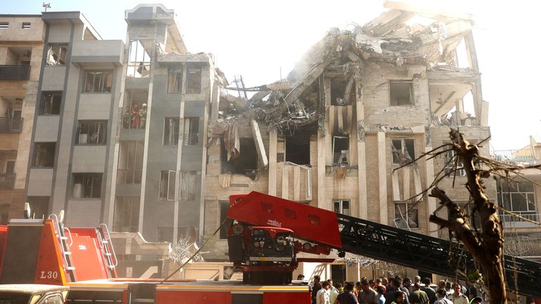 Rescuers work at the scene of a damaged building in the aftermath of Israeli strikes, in Tehran, Iran.
Pic: WANA/Reuters