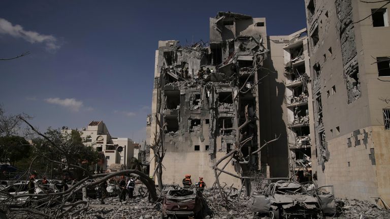 Israeli security forces inspect the site struck by an Iranian missile strike that killed several people, in Beersheba, Israel, on Tuesday, June 24, 2025. (AP Photo/Leo Correa)