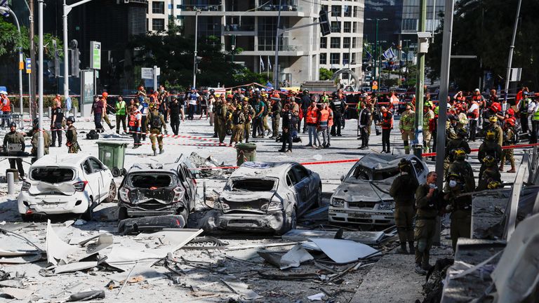 Emergency personnel work in Ramat Gan, Israel, following an Iranian missile strike. Pic: Reuters/Ammar Awad