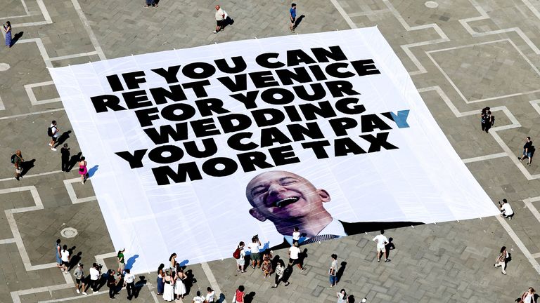 A banner against Jeff Bezos lies on the ground, placed by Greenpeace Italy activists along with others in St. Mark's Square.
Pic:  Reuters