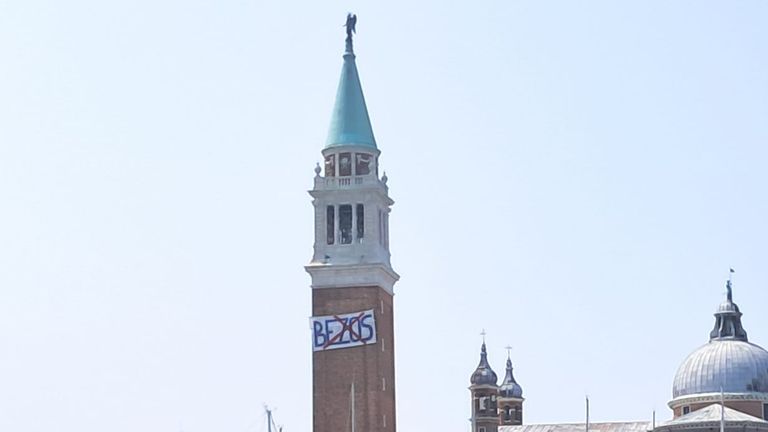 Anti Jeff Bezos sign hung by protesters on the bell tower of the San Giorgio Maggiore basilica. Pic: Federica Toninelli