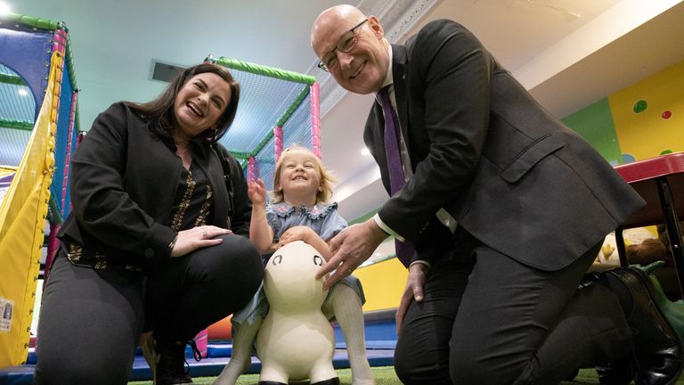 SNP leader and First Minister John Swinney and SNP candidate Katy Loudon with Grace Ure, aged 2, during a visit to Juniors Charity in Hamilt