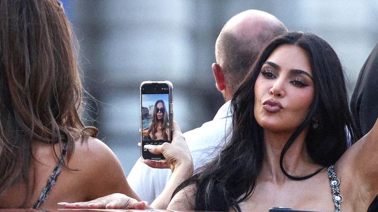 Kim Kardashian gestures on a boat as Khloe appears to take a selfie.
Pic: Reuters