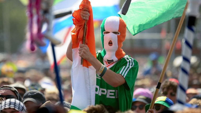 A reveller wears a balaclava in the colours of the Irish flag. Pic: Reuters