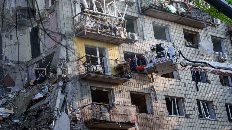 Rescue workers evacuate an injured woman from a window of a multi-storey residential house destroyed by a Russian strike in Kyiv, Ukraine, on Tuesday, June 17, 2025. (AP Photo/Evgeniy Maloletka)