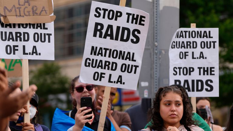 People protest against the ongoing immigration raids in Washington, D.C. Pic: AP/Julia Demaree Nikhinson