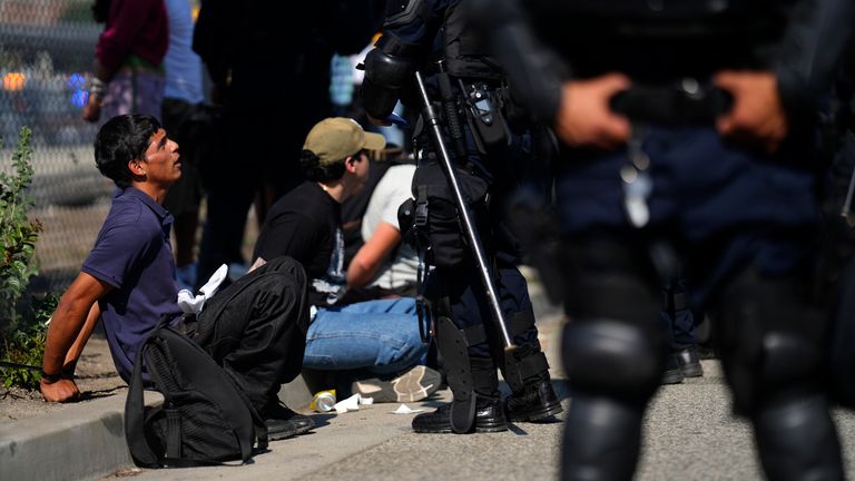 Protesters are detained by law enforcement near the federal building in downtown LA. Pic: AP/Eric Thayer