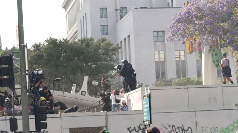 LAPD aiming crowd control weapons at people gathered in Los Angeles