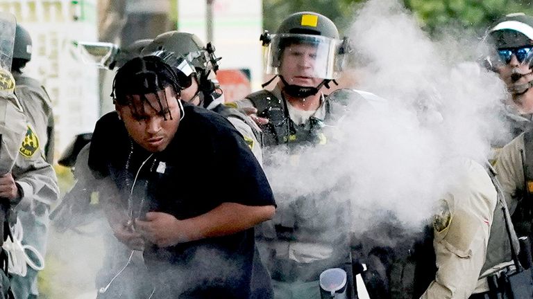 A person reacts to non-lethal munitions shot in Los Angeles.
Pic: Reuters