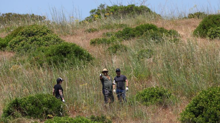 Criminal police investigators search the area near a ruin as police resumes the search for the body of Madeleine McCann, who went missing in
