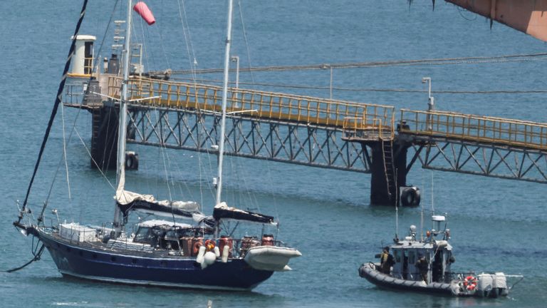Gaza-bound British-flagged yacht "Madleen" is docked next to a military boat Ashdod port following a takeover by the Israeli army, in Ashdod