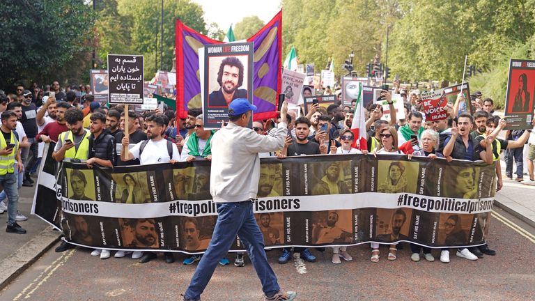People take part in a rally outside the Iranian Embassy in London to mark the one year anniversary of Mahsa Amini's death in Iran.
