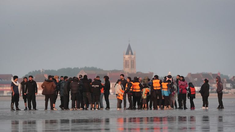 Migrants waited on the beach at Gravelines before boarding boats to the UK. Pic: PA