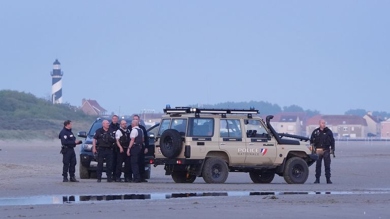 French police watched on as migrants boarded the boats in the water at Gravelines. Pic: PA