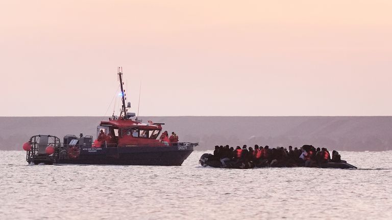 French authorities escort people thought to be migrants onboard a small boat leaving the beach at Gravelines, France on 31 May 25
