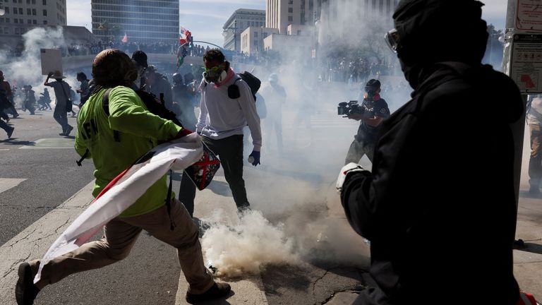 People run from tear gas in LA. Pic: Reuters